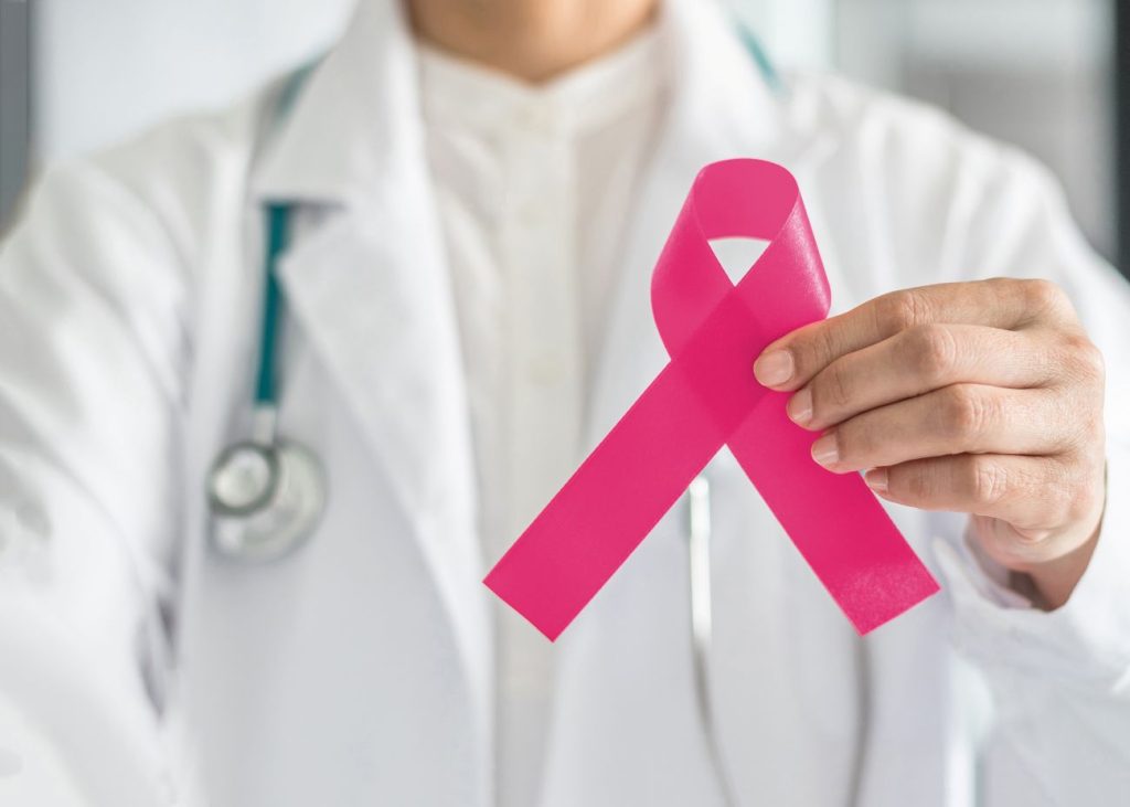 Pink Ribbon in Person's Hand