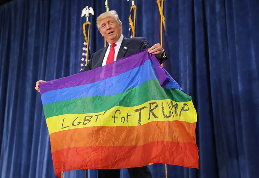 Donald Trump holding a rainbow LGBT for Trump flag