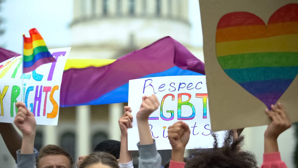 Crowd raising posters chanting to respect LGBT rights